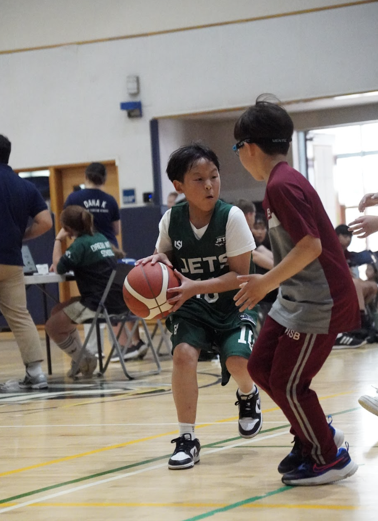 Fourth grader Ryan Kung aims for an ankle-breaking move, keeping the Bears on edge. He scans the court, eyes locked on his teammates and ready to deliver the pass.